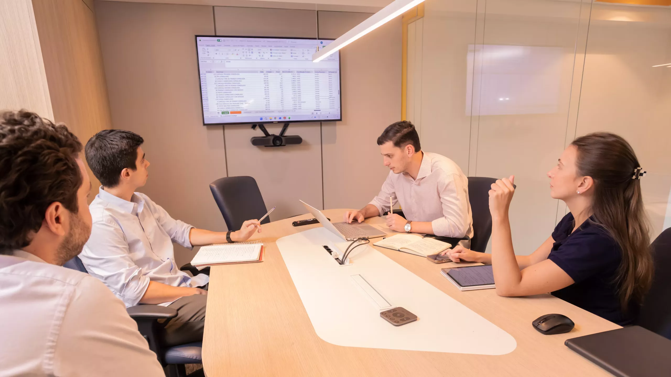 Operations team reviewing ERP implementation workflow and module configuration on screen